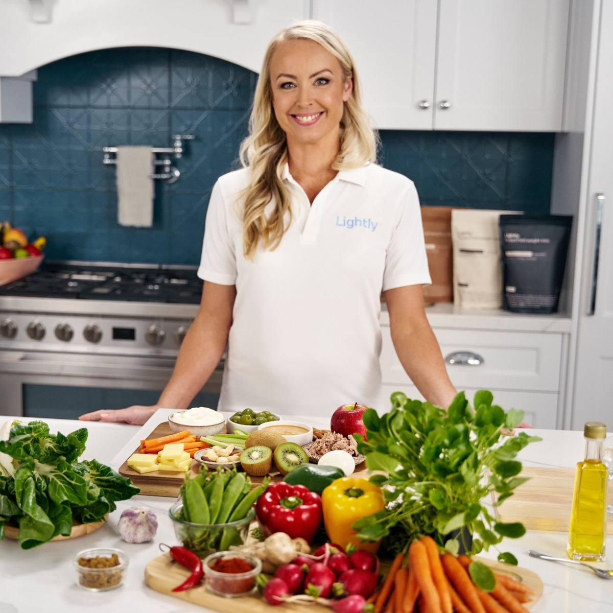 Carly, Lightly founder and dietitian, in the kitchen with fresh ingredients